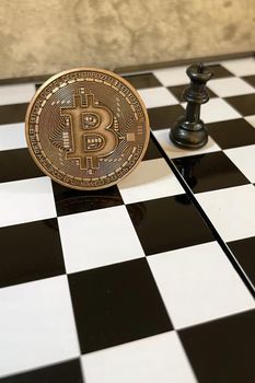 istanbul,Turkey.June 22,2022.cryptocurrency mining. Close-up bitcoin coin and chess game