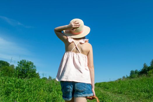 Little cute girl in the hat close-up portrait outdoors. The concept of a happy childhood. High quality photo