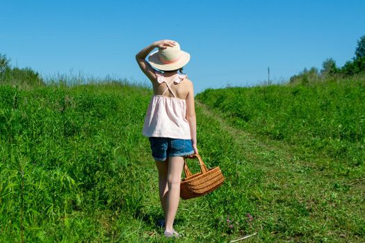 Little cute girl in the hat close-up portrait outdoors. The concept of a happy childhood. High quality photo