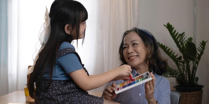 Asian portrait, grandchild granddaughter grandma grandmother and granddaughter happily join in activities to enhance skills for grandchildren