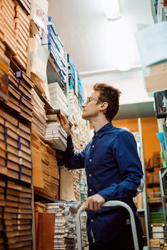 Student taking a book from shelf in library