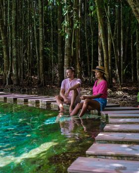 Emerald lake Blue pool Krabi Thailand mangrove forest Krabi Thailand. Young Asian woman and European men at the lake