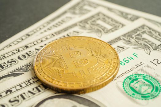 Golden bitcoin on US dollar banknotes money for business and commercial, Digital currency, Virtual cryptocurrency, blockchain technology.