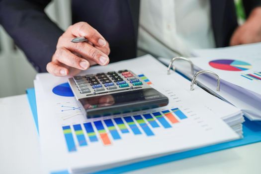 Businessman working and analysis with statistic graph in office.