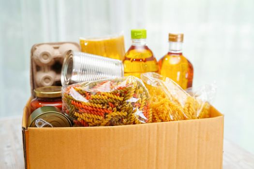 Foodstuffs in donation box for volunteer.