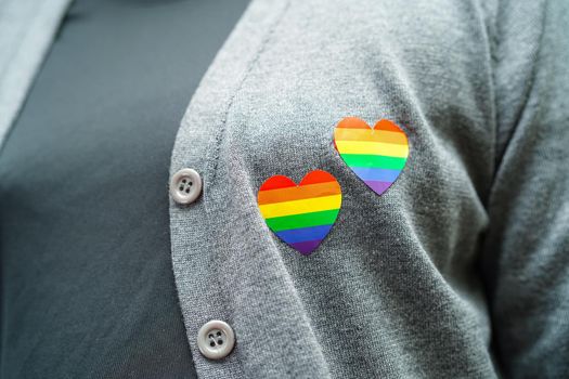 Asian woman with rainbow flag, LGBT symbol rights and gender equality, LGBT Pride Month in June.