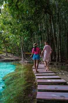 Emerald lake Blue pool Krabi Thailand mangrove forest Krabi Thailand. Young Asian woman and European men at the lake