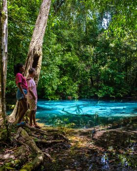 Emerald lake Blue pool Krabi Thailand mangrove forest Krabi Thailand. Young Asian woman and European men at the lake