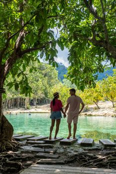 Emerald lake Blue pool Krabi Thailand mangrove forest Krabi Thailand. Young Asian woman and European men at the lake