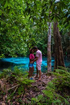Emerald lake Blue pool Krabi Thailand mangrove forest Krabi Thailand. Young Asian woman and European men at the lake