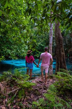 Emerald lake Blue pool Krabi Thailand mangrove forest Krabi Thailand. Young Asian woman and European men at the lake