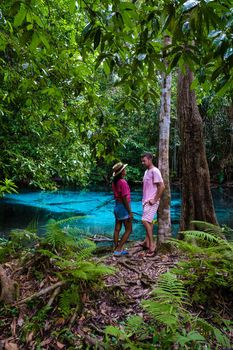 Emerald lake Blue pool Krabi Thailand mangrove forest Krabi Thailand. Young Asian woman and European men at the lake