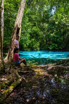 Emerald lake Blue pool Krabi Thailand mangrove forest Krabi Thailand. Young Asian woman and European men at the lake