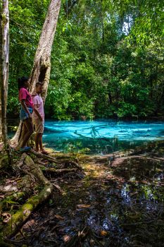 Emerald lake Blue pool Krabi Thailand mangrove forest Krabi Thailand. Young Asian woman and European men at the lake