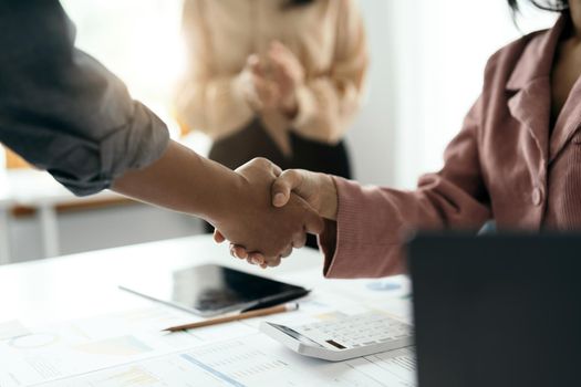 Business people shaking hands, finishing up meeting, business etiquette, congratulation, merger and acquisition concept.