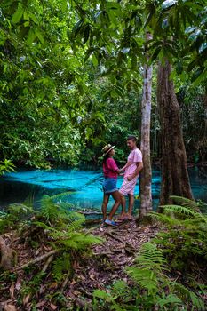 Emerald lake Blue pool Krabi Thailand mangrove forest Krabi Thailand. Young Asian woman and European men at the lake