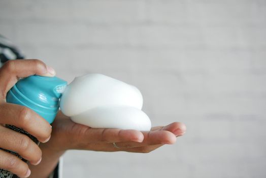 top view of shaving foam on hand .