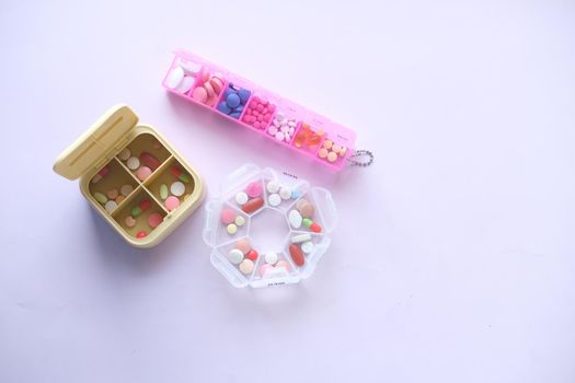 top view of medical pills in a pill box on white background .