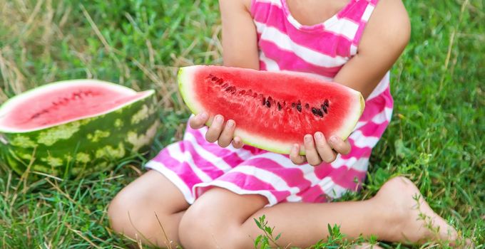 child eats a watermelon in the garden. Selective focus. nature.