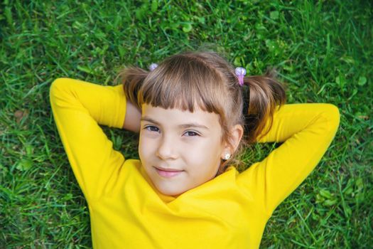 The child lies on the grass. Selective focus.