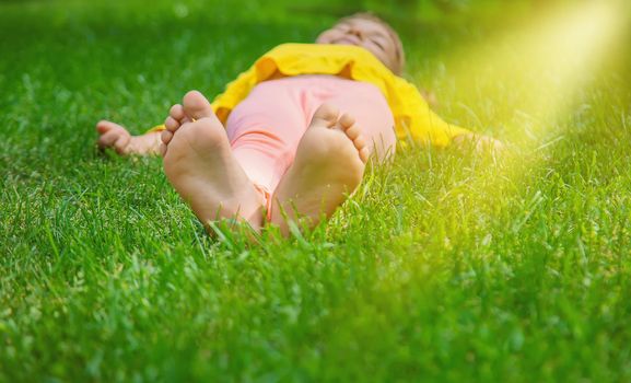 The child lies on the grass. Selective focus. nature.