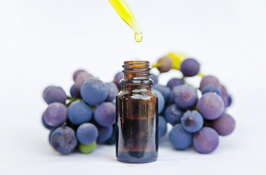 Grape seed oil in a small bottle. Selective focus. nature.