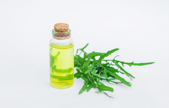 Arugula oil in a small bottle. Selective focus. nature.