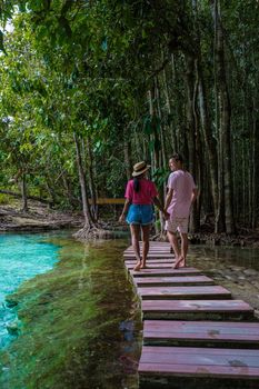 Emerald lake Blue pool Krabi Thailand mangrove forest Krabi Thailand. Young Asian woman and European men at the lake