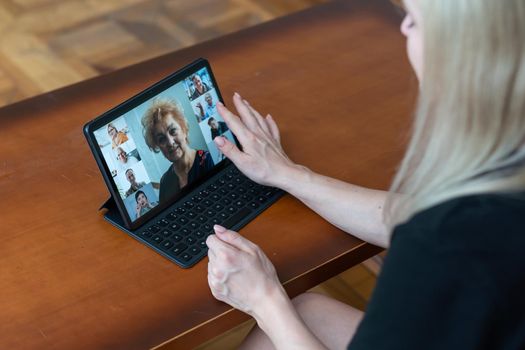 Woman talking with a online using digital tablet.