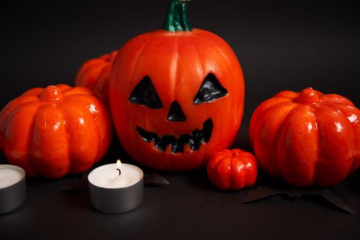 Halloween background, orange decorative plastic pumpkin black paper bat black cardboard Thanksgiving greeting card pattern