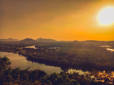 A beautiful valley in the Prachubkeereekhan Thailand, with a river running through the tropical forest sunset of summer.