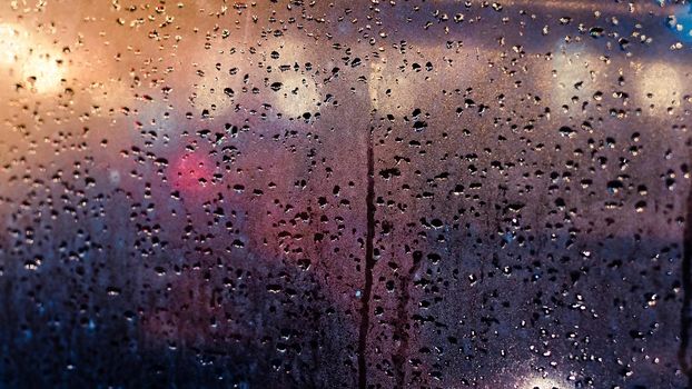 Abstract traffic in raining day. View from car seat. Rainy days, Rain drops on window, rainy weather, rain and bokeh