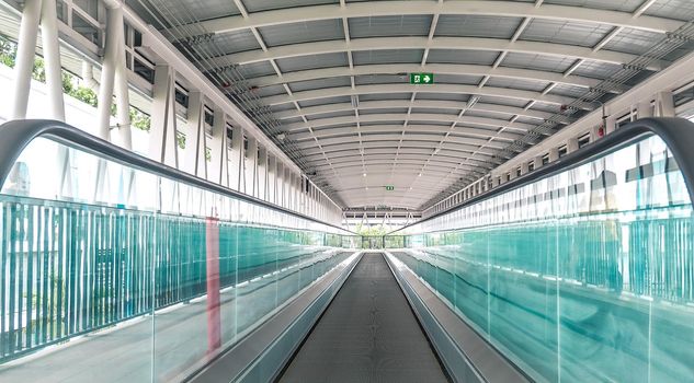 Modern walkway of escalator move forward and escalator move backward in international airport. Escalator is facility for support transportation