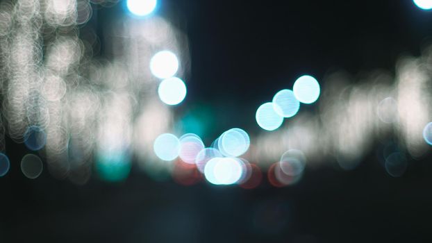 Defocused night Street lights. Bokeh street lights from cars in the city.