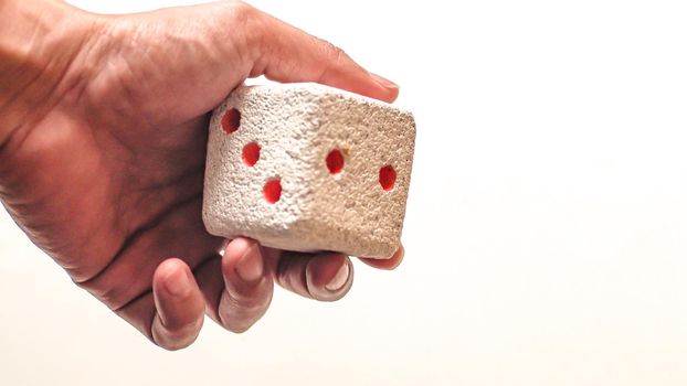 Hand & Rolling Dice. Hand rolls a dices on white isolated background. Selective focus. Dice is blur due to movement. Roll the dice concept