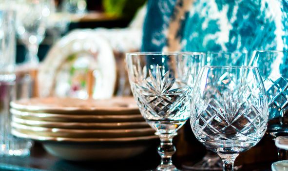 Set of Vintage crystal glasses on the black tray with Christmas decorations. Selective focus