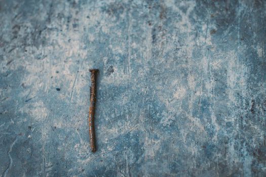 old rust nail on concrete background abstract construction business industry