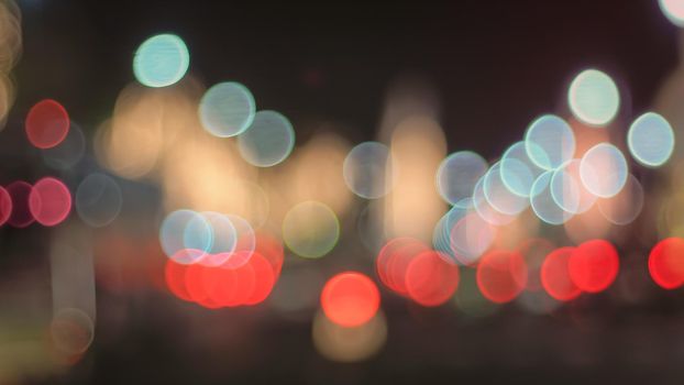 Defocused night Street lights. Bokeh street lights from cars in the city.