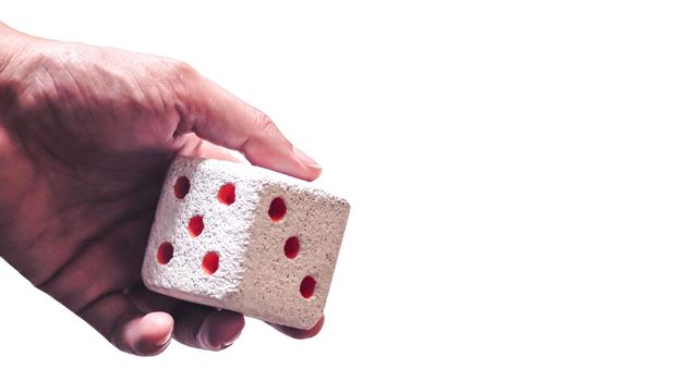 Hand & Rolling Dice. Hand rolls a dices on white isolated background. Selective focus. Dice is blur due to movement. Roll the dice concept