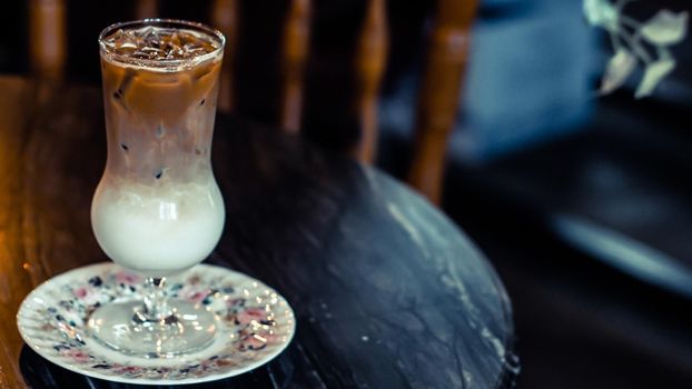 Chocolate frappe on wooden table background of Restaurant with vintage style interior