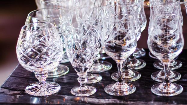 Close up picture of empty crystal wine glasses in restaurant