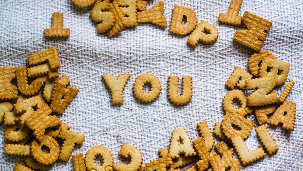 find you concept Cookies in the form of the alphabet prospect .Happy from homemade cookies on dark white background. Happy cookies concept.