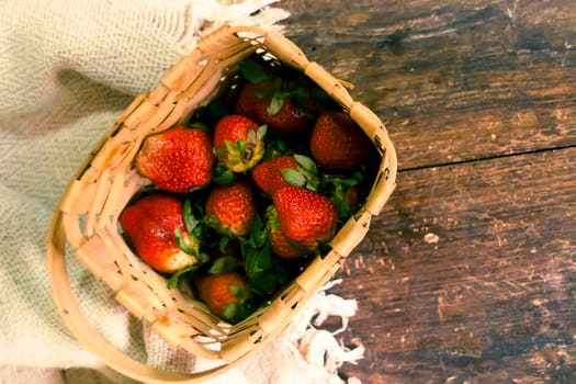 Strawberry in woven basket. Fresh strawberry. Red strawberry. Strawberry Juice. Wooden table background