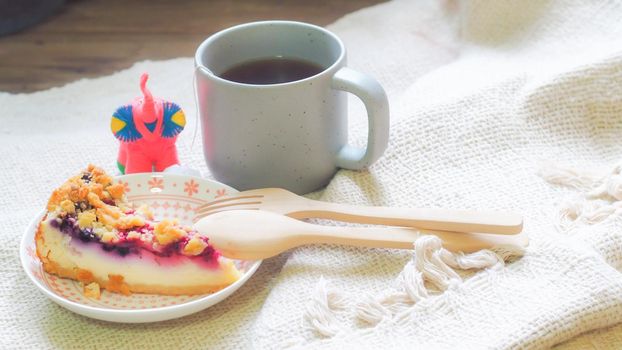 blueberry cheese cake on plate and a cup of coffee morning breakfast