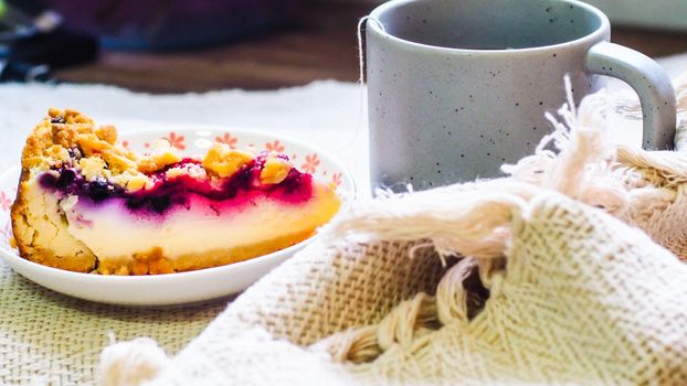 blueberry cheese cake on plate and a cup of coffee morning breakfast