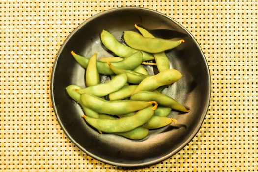 Green soya beans in dish. Japanese healthy dish idea abstract clean food background