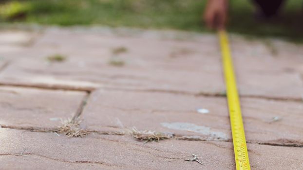 Tape measure road. Men's hands hold a measuring tape. Construction, engineering, repair concept