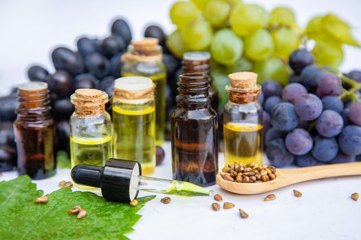 Grape seed oil in a small bottle. Selective focus. nature.