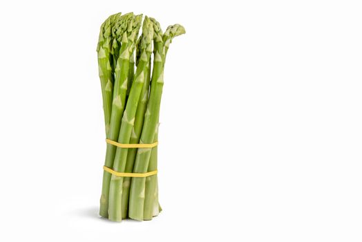 Bunch of fresh green asparagus isolated on white background. Freshly picked asparagus with water drops isolated on white background