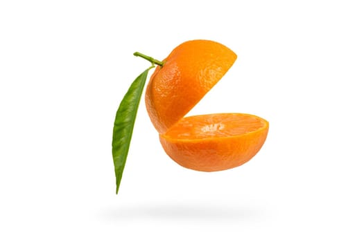 Mandarin cut in half with a green leaf. Fresh tangerine on a white isolated background. Open mouth concept. Tangerine texture close up